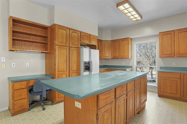 kitchen featuring brown cabinetry, light floors, a kitchen island, open shelves, and white fridge with ice dispenser