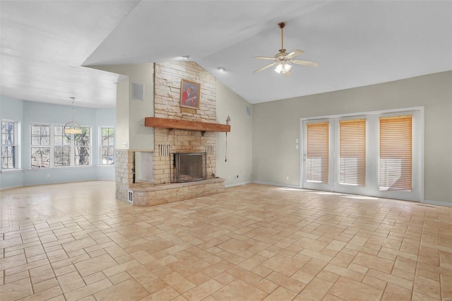 unfurnished living room with visible vents, high vaulted ceiling, a ceiling fan, a stone fireplace, and baseboards