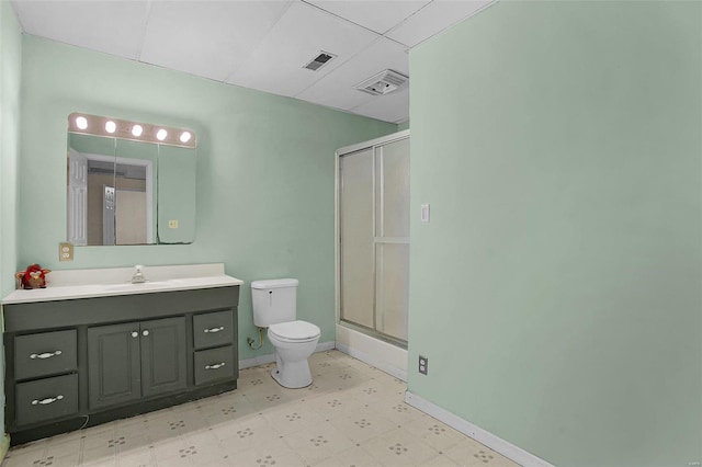 bathroom featuring visible vents, baseboards, toilet, a shower with shower door, and tile patterned floors