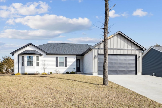 view of front of property with a garage, driveway, a front lawn, and a shingled roof