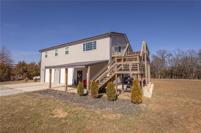 exterior space with stairs, driveway, and a garage