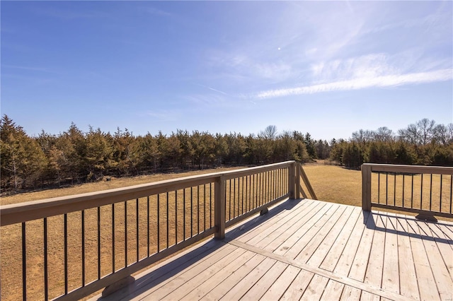 wooden deck with a wooded view