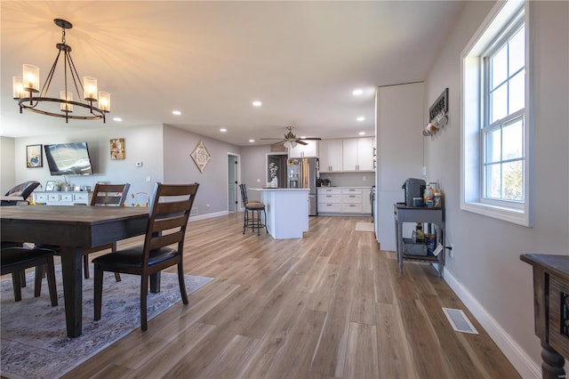 dining space with recessed lighting, visible vents, light wood-style flooring, and baseboards