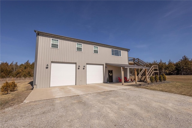 view of front of house with stairs and driveway