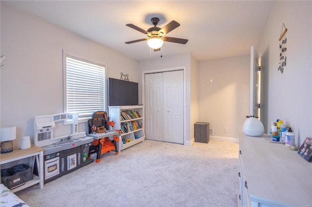 rec room with a ceiling fan, carpet, and baseboards