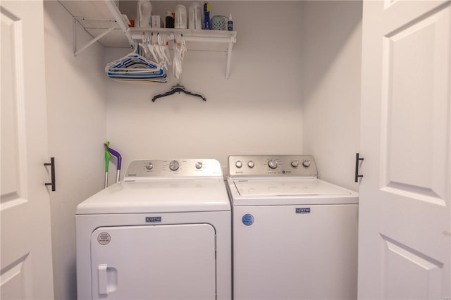 clothes washing area with laundry area and washer and clothes dryer