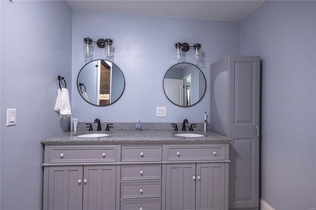 bathroom featuring double vanity and a sink