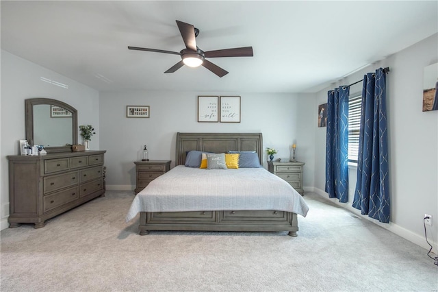 bedroom featuring light carpet, ceiling fan, and baseboards