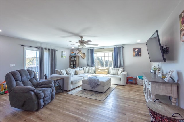 living room with light wood-style flooring, ceiling fan, and recessed lighting