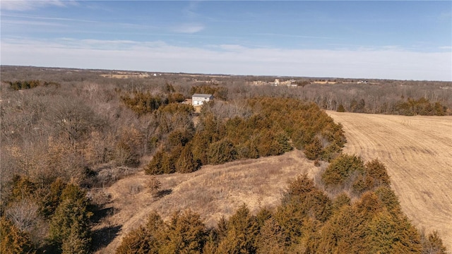 drone / aerial view with a wooded view