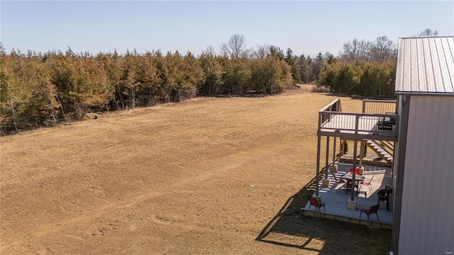 view of yard with stairway and a deck