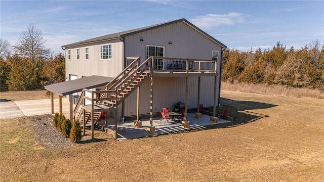 exterior space featuring a patio area, stairway, and a wooden deck