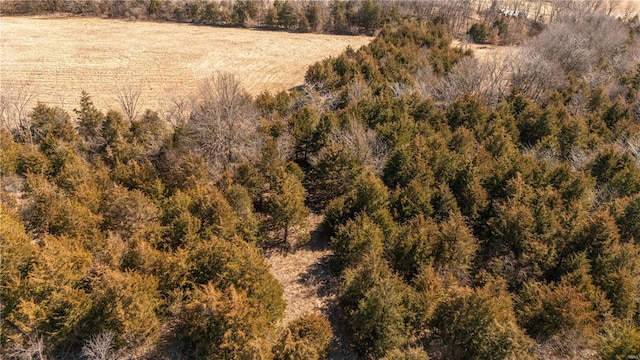 drone / aerial view featuring a wooded view