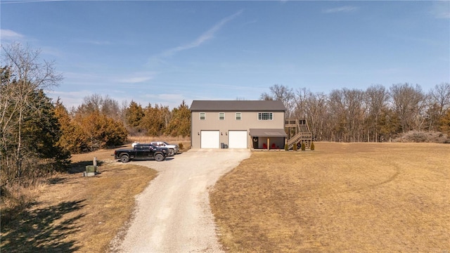 view of front of home with an attached garage, stairway, and dirt driveway