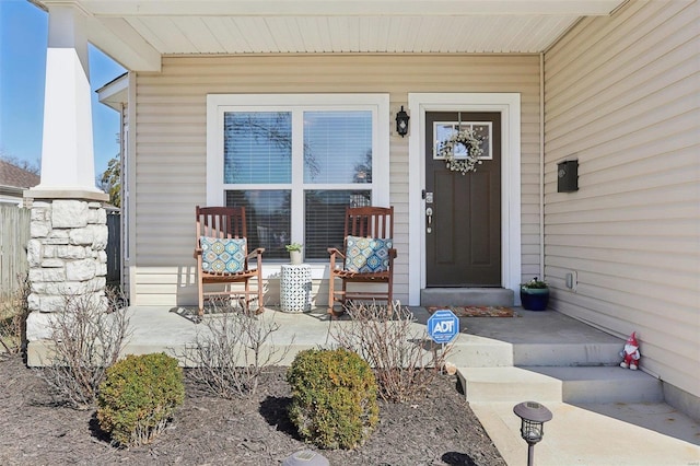 view of exterior entry with a porch