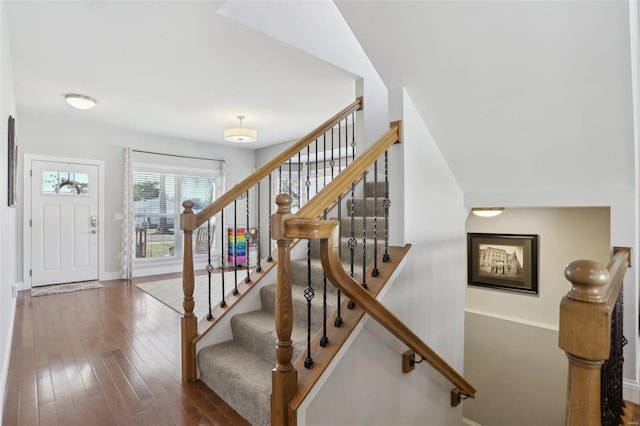 stairway featuring hardwood / wood-style floors and baseboards