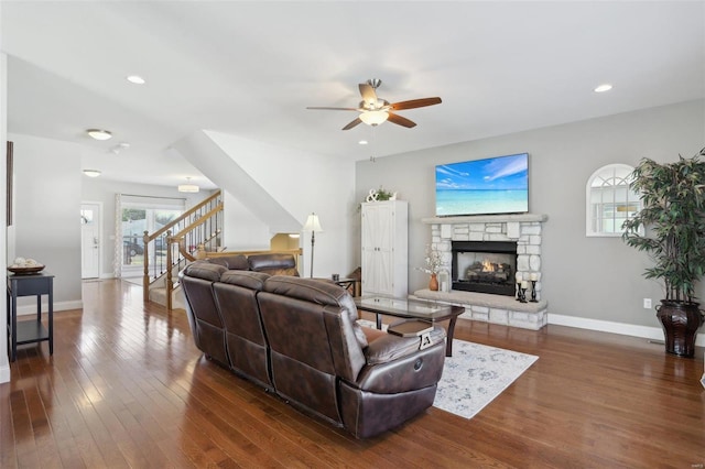 living area featuring dark wood finished floors, recessed lighting, stairway, a fireplace, and baseboards