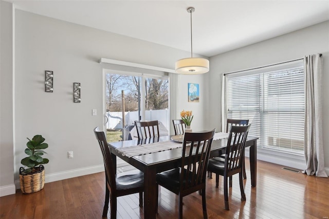 dining area featuring visible vents, baseboards, and hardwood / wood-style floors