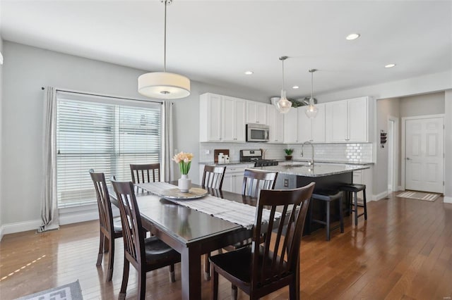 dining area with recessed lighting, baseboards, and wood-type flooring