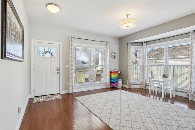 entryway with wood finished floors and baseboards