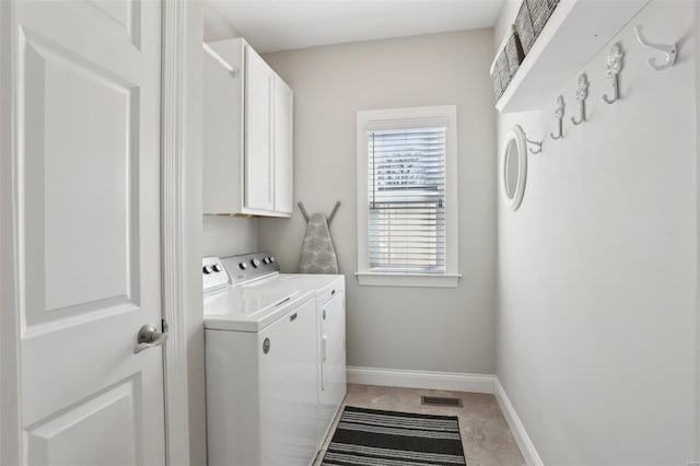 laundry room with cabinet space, visible vents, washing machine and dryer, and baseboards