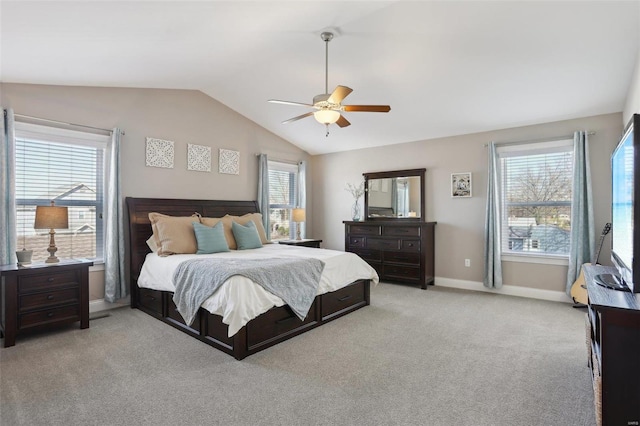 bedroom featuring light carpet, ceiling fan, baseboards, and lofted ceiling