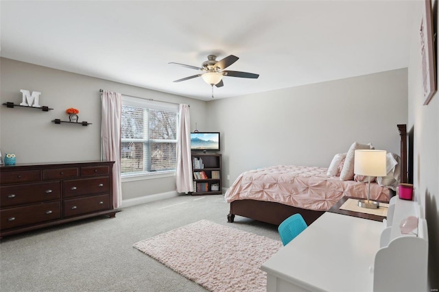 bedroom with light carpet, ceiling fan, and baseboards