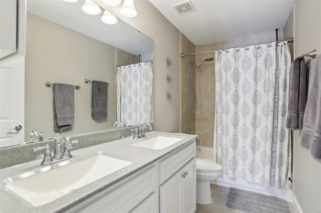 bathroom featuring a sink, visible vents, toilet, and shower / tub combo