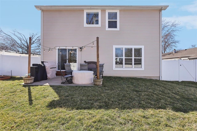 rear view of house featuring a gate, a yard, a patio area, and a fenced backyard