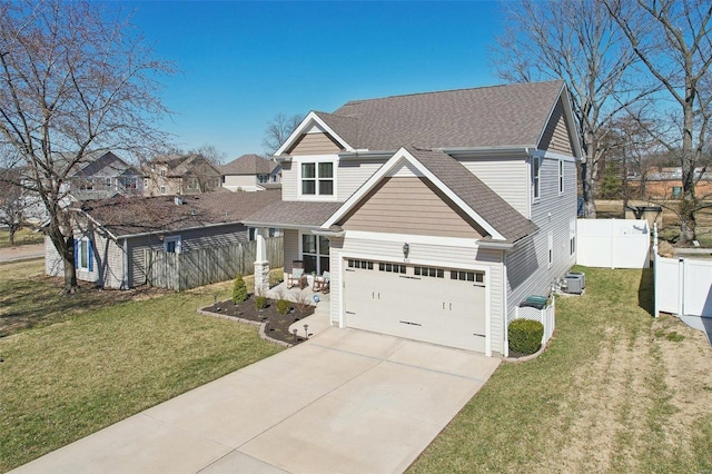 view of front of property featuring fence, roof with shingles, concrete driveway, a front yard, and central AC unit