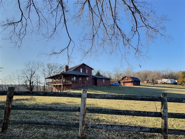 view of yard featuring dirt driveway, fence, and a wooden deck