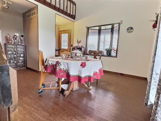 dining room with baseboards, visible vents, and wood finished floors