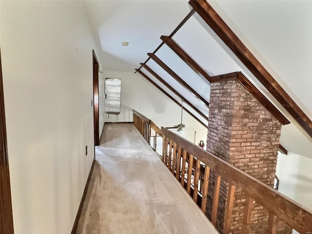 hallway featuring lofted ceiling and carpet floors