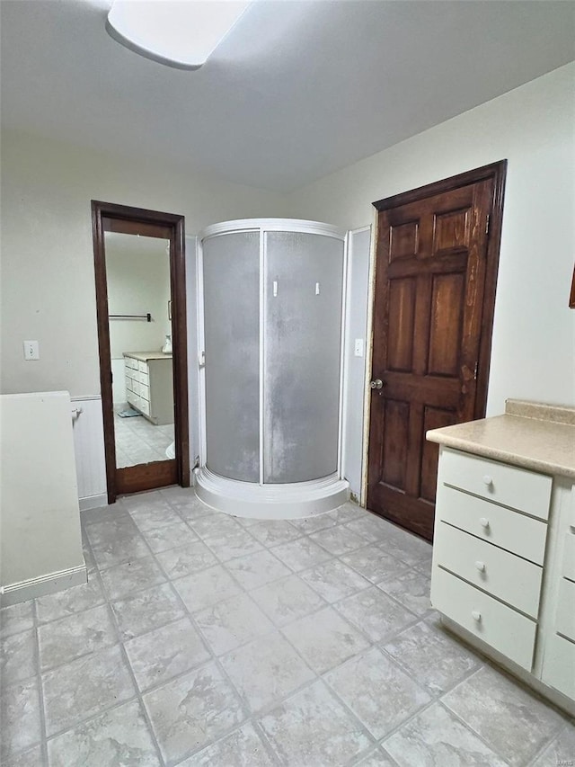 bathroom featuring a shower stall and vanity