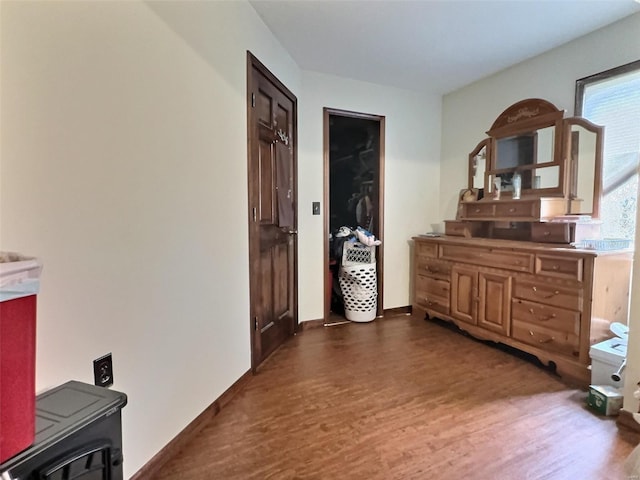 interior space featuring baseboards and wood finished floors