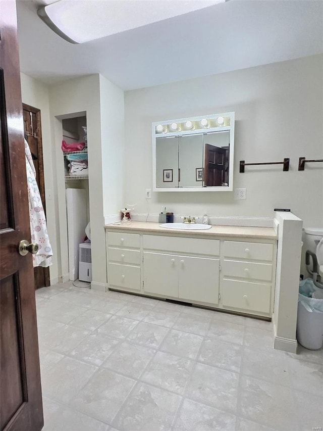 bathroom featuring baseboards and vanity