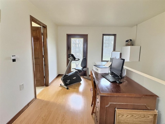 office area with light wood finished floors and baseboards