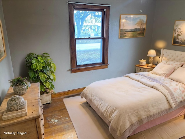 bedroom featuring baseboards and hardwood / wood-style floors