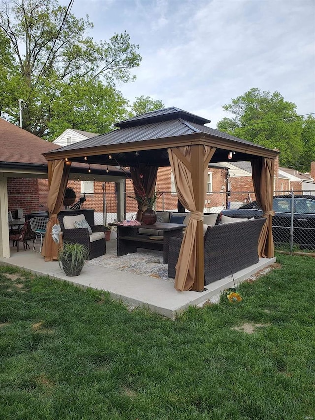 view of patio / terrace featuring fence, an outdoor living space, and a gazebo