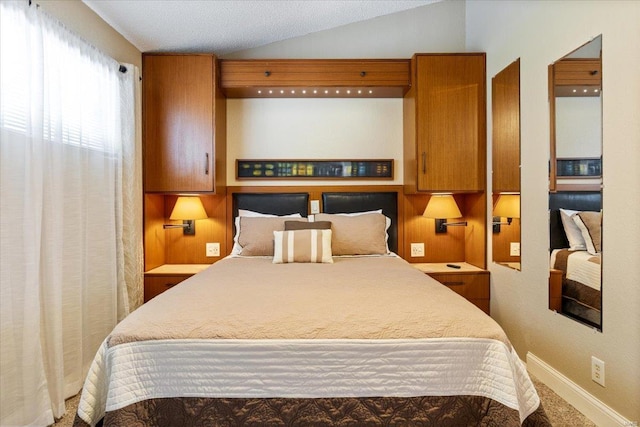 bedroom featuring lofted ceiling and baseboards