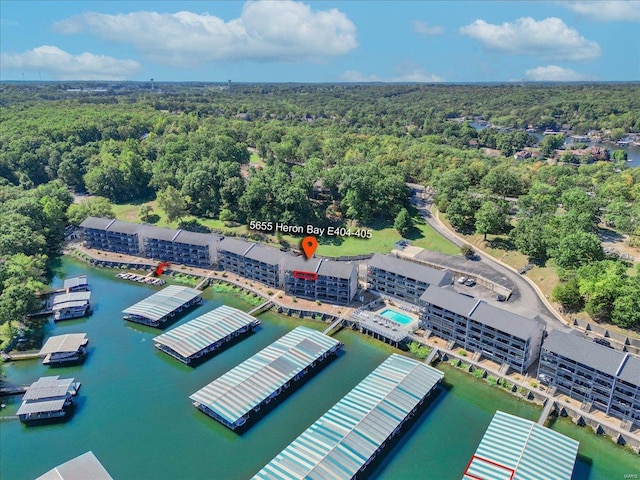 drone / aerial view featuring a forest view and a water view