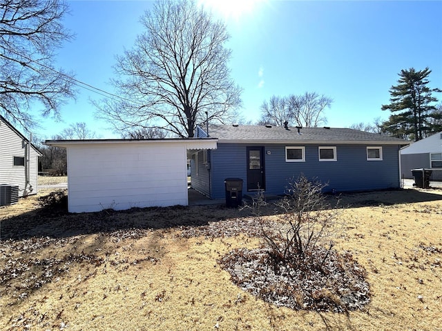 rear view of property with central AC unit