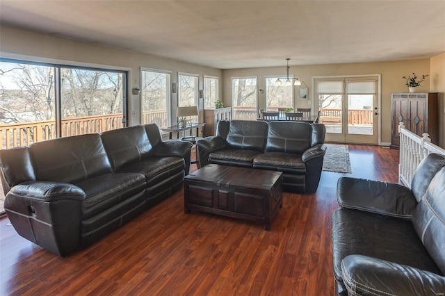 living room with dark wood-style floors and plenty of natural light