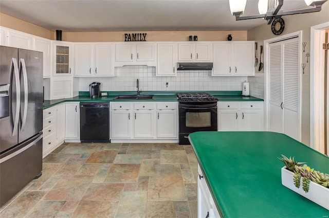 kitchen featuring dark countertops, a sink, range hood, black appliances, and backsplash