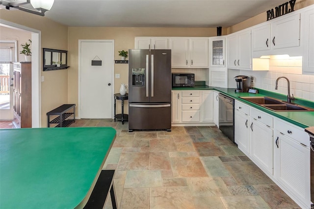 kitchen with a sink, white cabinetry, decorative backsplash, black appliances, and dark countertops