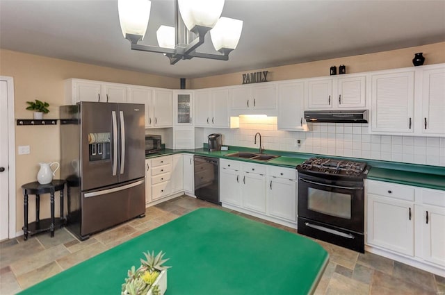 kitchen with dark countertops, white cabinetry, a sink, black appliances, and extractor fan