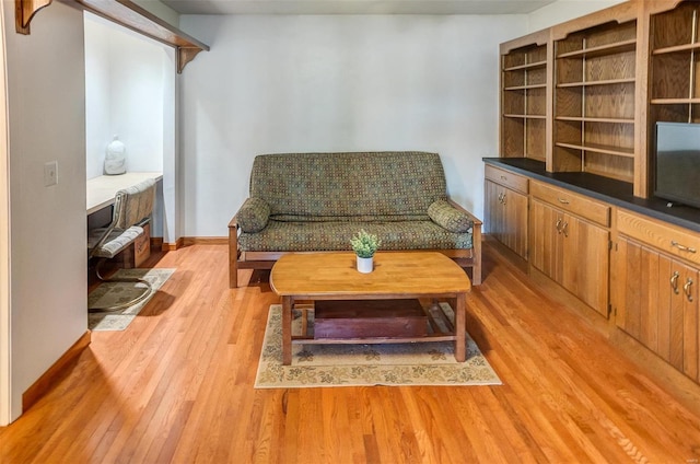 sitting room featuring light wood finished floors and baseboards