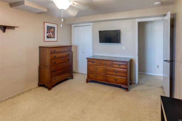 bedroom with light carpet and a ceiling fan