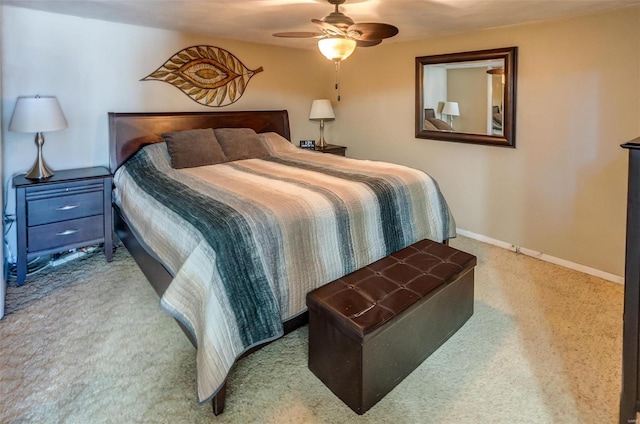 carpeted bedroom featuring baseboards and a ceiling fan