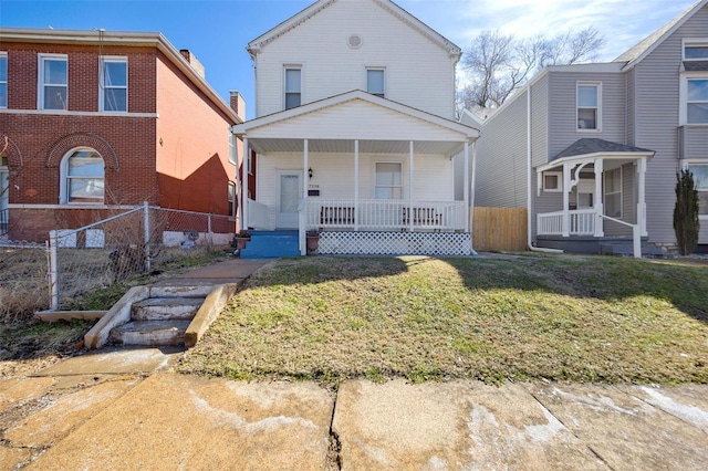 view of front of property with covered porch, a front lawn, and fence